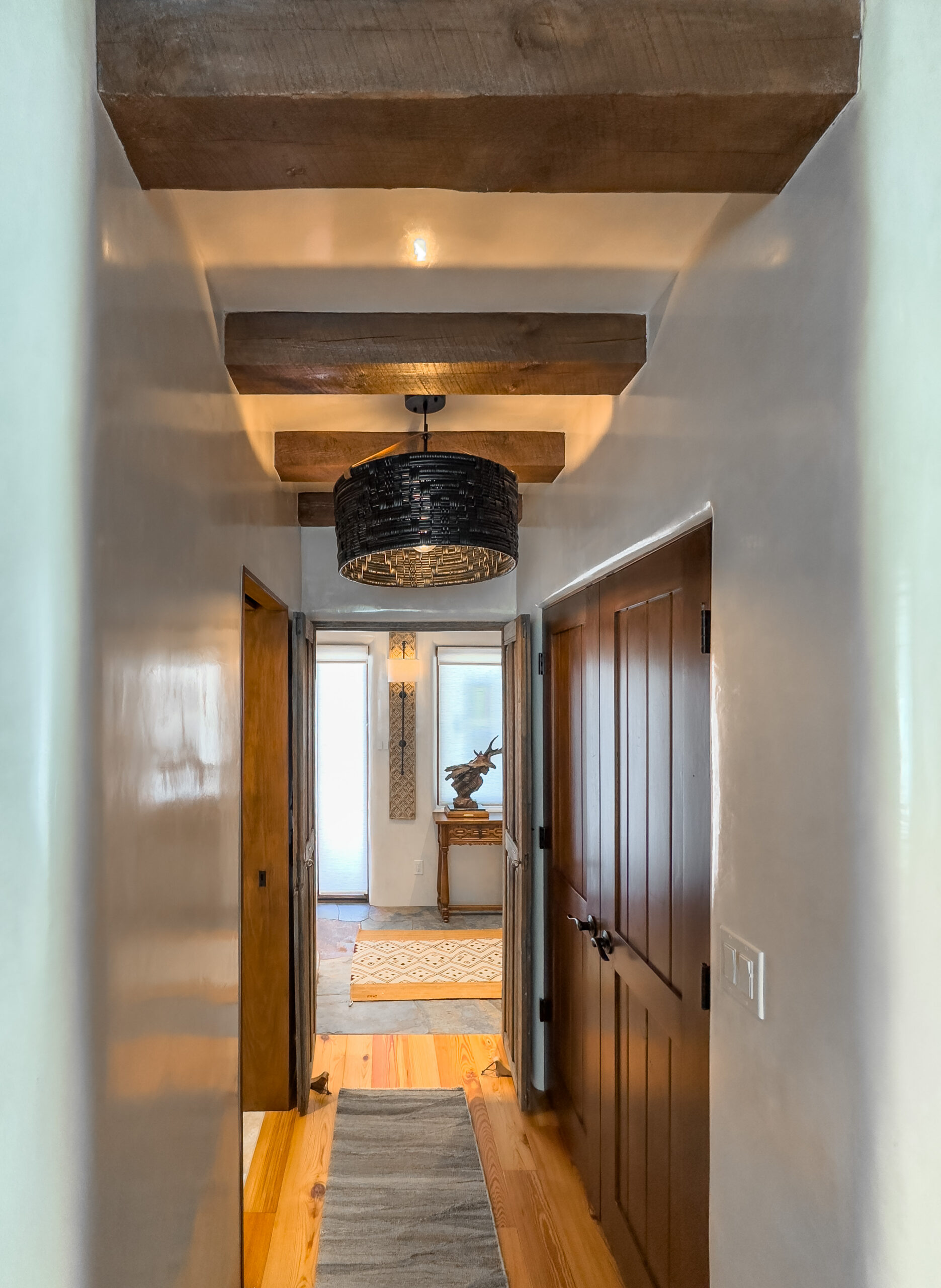 hirez©danielquatphoto-IMG_2142 Hallway adobe plaster santa fe style with wooden doors, wooden flooring.